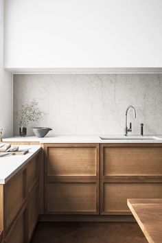 a kitchen with wooden cabinets and white counter tops