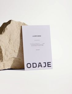 a piece of paper sitting on top of a rock with the word odaie printed on it