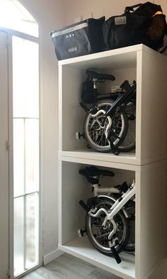 two bikes are sitting on top of the shelves