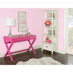 a pink desk with two shelves and a lamp