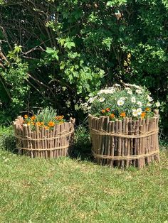 two baskets made out of sticks and flowers in the grass next to some shrubbery