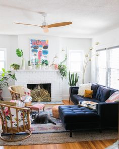 a living room filled with furniture and a fire place under a painting on the wall