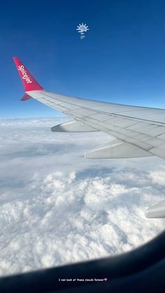 the wing of an airplane flying over clouds