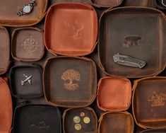 many different types of leather trays with trees on them