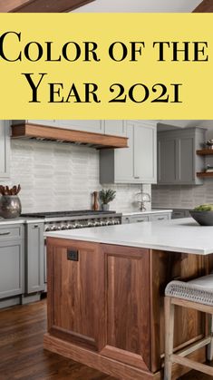 the color of the year 2021 is shown in this kitchen with white cabinets and wood floors