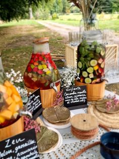 a table topped with jars filled with different types of candies next to other items