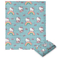 hello kitty bedding set with blue background and rainbows on the ground, including a pillow