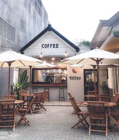 an outdoor cafe with umbrellas and chairs