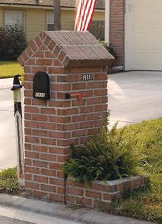 a brick mailbox with an american flag on top