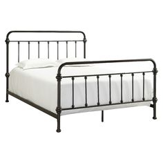 a black metal bed frame with white sheets