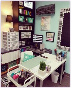 a desk with lots of crafting supplies on top of it in front of a blue wall