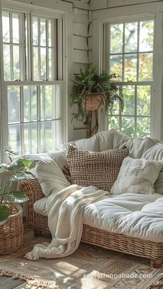 a living room with wicker furniture and plants in the window sill, all white