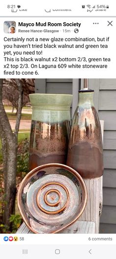 two vases sitting on top of a wooden table next to each other with the same color