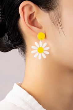 Daisy Drop Earrings: These lightweight acrylic daisy drop earrings make the perfect 90s throwback accessory! Made of white and yellow acrylic with push pack posts to keep them secure.Length: 1 inches x 1.5 inches Trendy White Plastic Earrings, Trendy White Earrings, Trendy Yellow Plastic Earrings, White Flower-shaped Trendy Earrings, Trendy White Flower-shaped Earrings, Retro White Flower Jewelry, White Daisy Flower Earrings For Spring, Daisy-shaped Earrings For Summer, Daisy Shaped Earrings For Summer