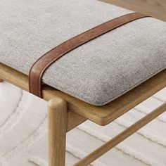 a close up of a wooden chair with a cushion on it's backrest