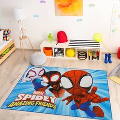 a kid's room with spiderman rugs and toys