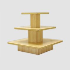 three tiered wooden display stand with one shelf on the top and two shelves below