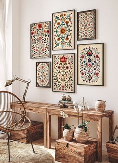 a living room filled with furniture and pictures on the wall above it's table