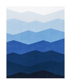 an abstract blue and white quilt with mountains in the background