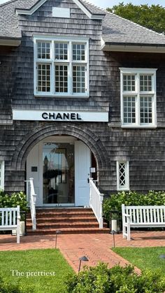 the entrance to chanel is shown in front of an old building with white doors and windows