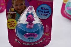 a pink and blue toothbrush with a purple dragon on it's head in a packaging