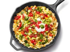 a skillet filled with vegetables and sour cream