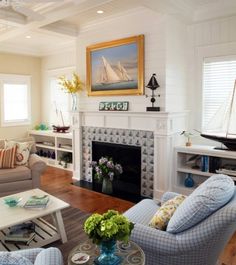 a living room filled with furniture and a fire place under a painting on the wall