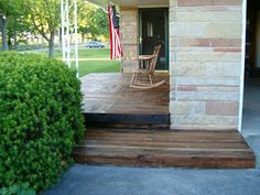 a porch with a rocking chair and american flag on it