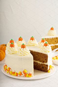 a slice of cake with white frosting and candy on the side is sitting on a plate