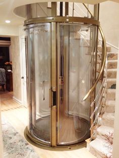 a spiral staircase with a glass case in the middle