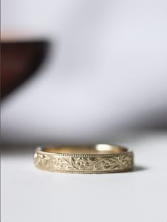 a gold wedding band sitting on top of a table