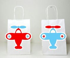 two paper bags with red and blue planes on them