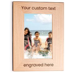 a wooden frame with an image of three children playing in the water and texting your custom text