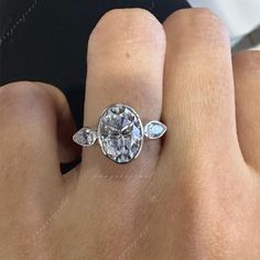 a woman's hand with a diamond ring on it