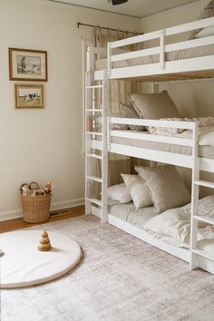 a room with bunk beds and pillows in it