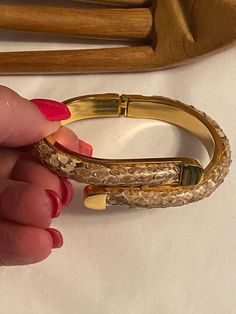 "When I was a working lady and loaded my wrists with bracelets of all kinds, this style of hinged bangle was a favorite style.   This bracelet is for a small wrist and will fit right at the wrist bone.  No name but it is heavily gold plated.  3/8\" wide. The brownish beige taupe color of the bangle is snake skin, roughly textured and very organic.  As I wore this I periodically applies a clear lacquer to keep the scales from drying out and/or peeling away.   So unlike a faux snake skin, this has Snake Skin Bracelet, Working Lady, Snake Bangle, Chic Shirts, Taupe Color, Hinged Bangle, Gold Style, Scales, Bangle Bracelet