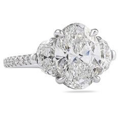 an oval cut diamond ring with three stone shoulders