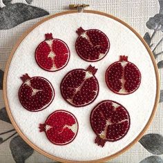 six pomegranates are displayed on a white embroideryed wallhangle