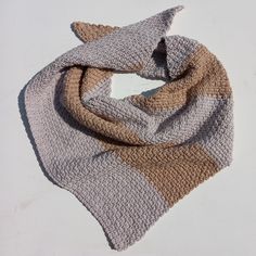 a crocheted scarf on a white surface