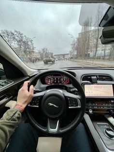 a person driving a car on a city street