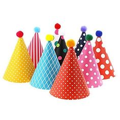 small party hats with polka dots and pom poms on them are lined up against a white background