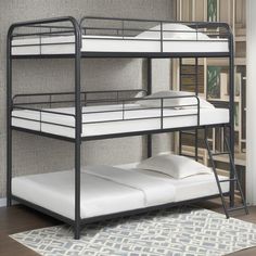 a bunk bed with white sheets and pillows on the bottom shelf next to a rug