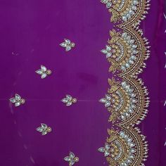 an embroidered purple fabric with gold and white beads