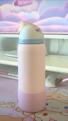 a pink and blue water bottle sitting on top of a table