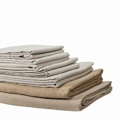 a stack of folded linens sitting on top of each other