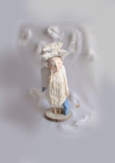 a small figurine with feathers on it's head