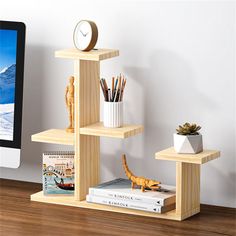 a computer monitor sitting on top of a desk next to a wooden shelf filled with books