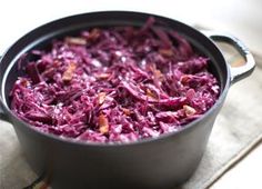 a pot filled with red cabbage on top of a table