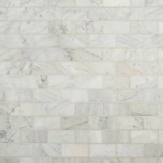 a white marble tile wall that looks like it is made out of different types of tiles