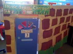 there is a cardboard box that has been made into a wall with the words three bears cottage on it